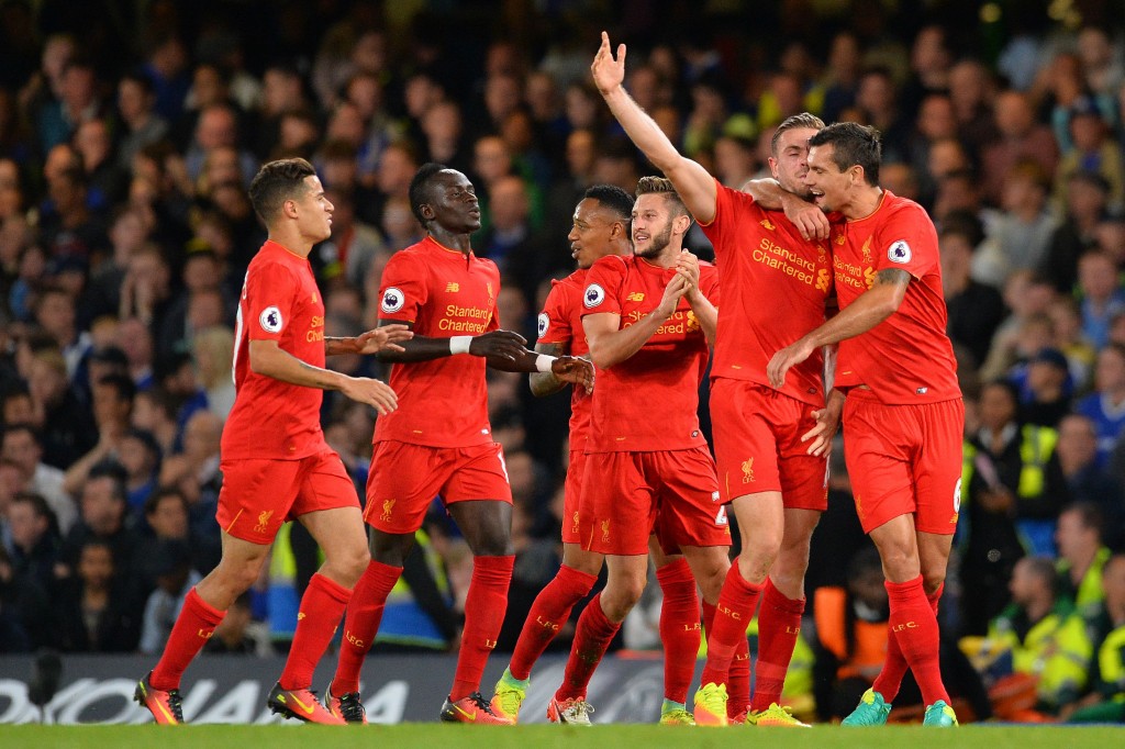 Liverpool's English midfielder Jordan Henderson (2R) celebrates with Liverpool's Croatian defender Dejan Lovren (R) after scoring his team's second goal during the English Premier League football match between Chelsea and Liverpool at Stamford Bridge in London on September 16, 2016. / AFP / GLYN KIRK / RESTRICTED TO EDITORIAL USE. No use with unauthorized audio, video, data, fixture lists, club/league logos or 'live' services. Online in-match use limited to 75 images, no video emulation. No use in betting, games or single club/league/player publications. / (Photo credit should read GLYN KIRK/AFP/Getty Images)