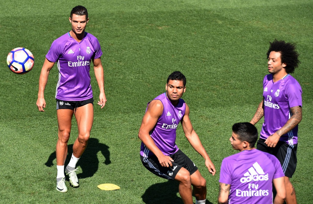 (From left) Real Madrid's Portuguese forward Cristiano Ronaldo, Real Madrid's Brazilian midfielder Casemiro, Real Madrid's Colombian midfielder James Rodriguez and Real Madrid's Brazilian defender Marcelo eye the ball during a training session at Valdebebas training ground in Madrid on September 9, 2016, on the eve of the Spanish League match Real Madrid CF vs Osasuna. / AFP / GERARD JULIEN (Photo credit should read GERARD JULIEN/AFP/Getty Images)