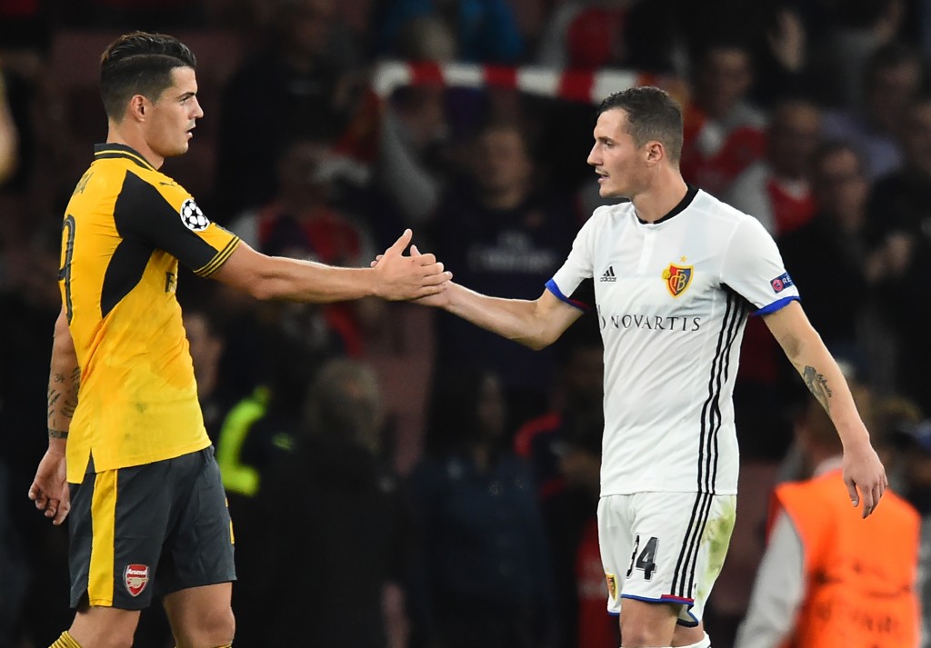 Arsenal's Swiss midfielder Granit Xhaka (L) shakes hands with his brother Basel's Albanian midfielder Taulant Xhaka after the UEFA Champions League Group A football match between Arsenal and FC Basel at The Emirates Stadium in London on September 28, 2016. Arsenal won the game 2-0. / AFP / IKIMAGES / Glyn KIRK (Photo credit should read GLYN KIRK/AFP/Getty Images)