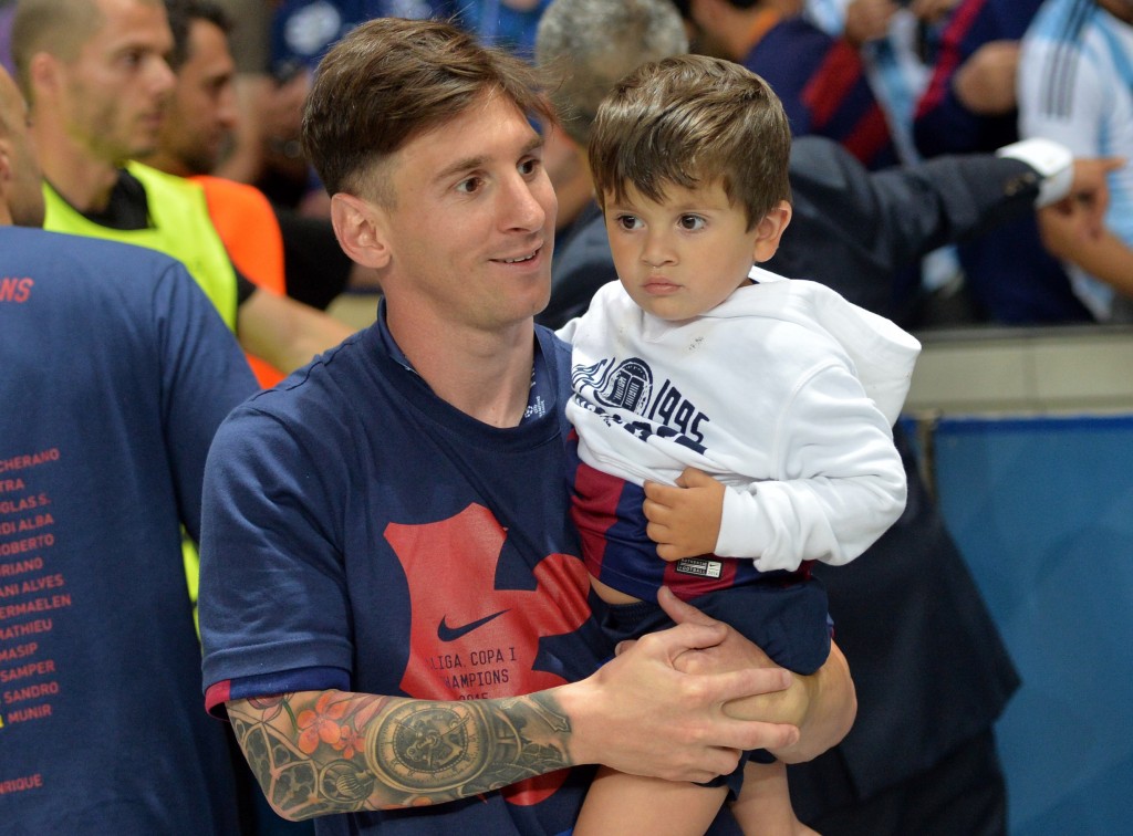 Barcelona's Argentinian forward Lionel Messi carries his son Thiago after the UEFA Champions League Final football match between Juventus and FC Barcelona at the Olympic Stadium in Berlin on June 6, 2015. FC Barcelona won the match 1-3. AFP PHOTO / OLIVER LANG (Photo credit should read OLIVER LANG/AFP/Getty Images)