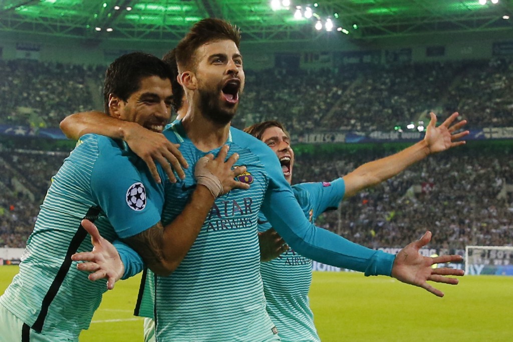 Barcelona's defender Gerard Pique (C) celebrates scoring the 1-2 goal with his teammates during the UEFA Champions League first-leg group C football match between Borussia Moenchengladbach and FC Barcelona at the Borussia Park in Moenchengladbach, western Germany on September 28, 2016. / AFP / Odd ANDERSEN (Photo credit should read ODD ANDERSEN/AFP/Getty Images)