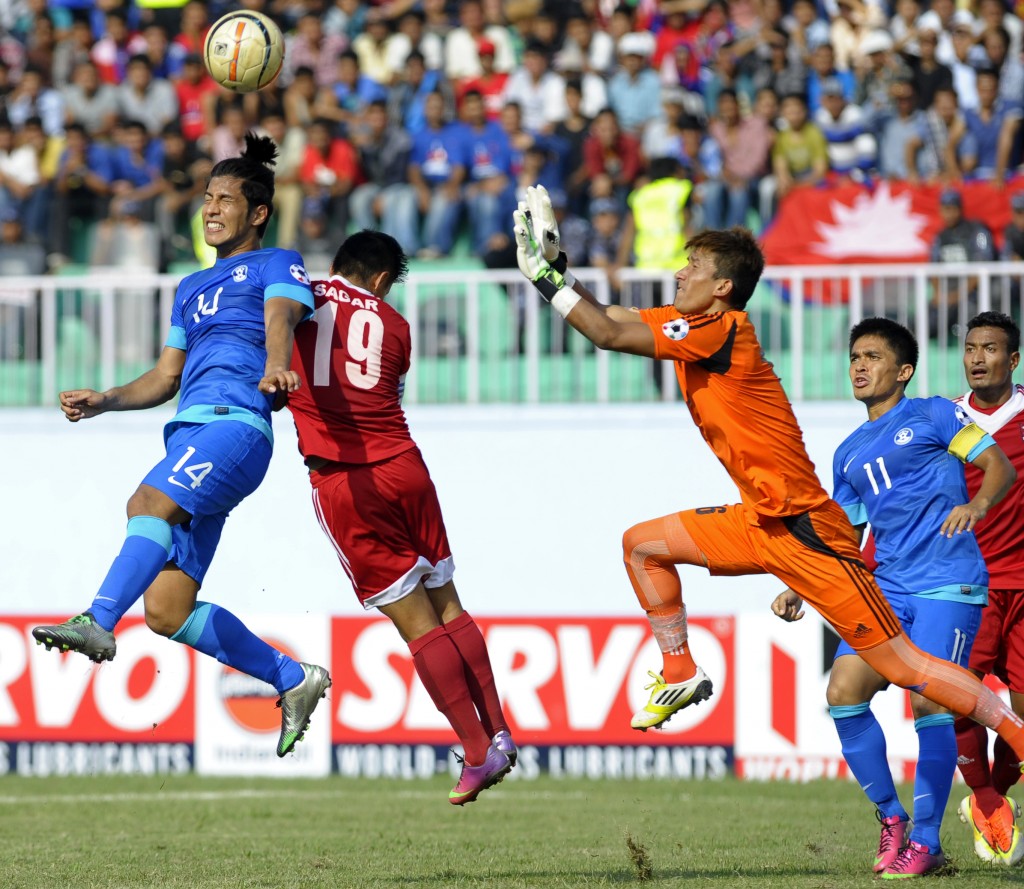 Nepalese goalkeeper Kiran Kumar Limbu (R) breaks out for a save as Indian football player Arata Izumi (L) attempts a goal during their SAFF Championship football match in Kathmandu on September 5, 2013. Nepal won 2-1. AFP PHOTO / Prakash MATHEMA (Photo credit should read PRAKASH MATHEMA/AFP/Getty Images)