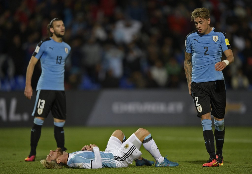 Argentina's Lionel Messi (C) gestures amid Uruguay's Gaston Silva (L) and Uruguay's Jose Maria Gimenez during the FIFA World Cup 2018 qualifier football match between Argentina and Uruguay in Mendoza, Argentina, on September 1, 2016. / AFP / JUAN MABROMATA (Photo credit should read JUAN MABROMATA/AFP/Getty Images)