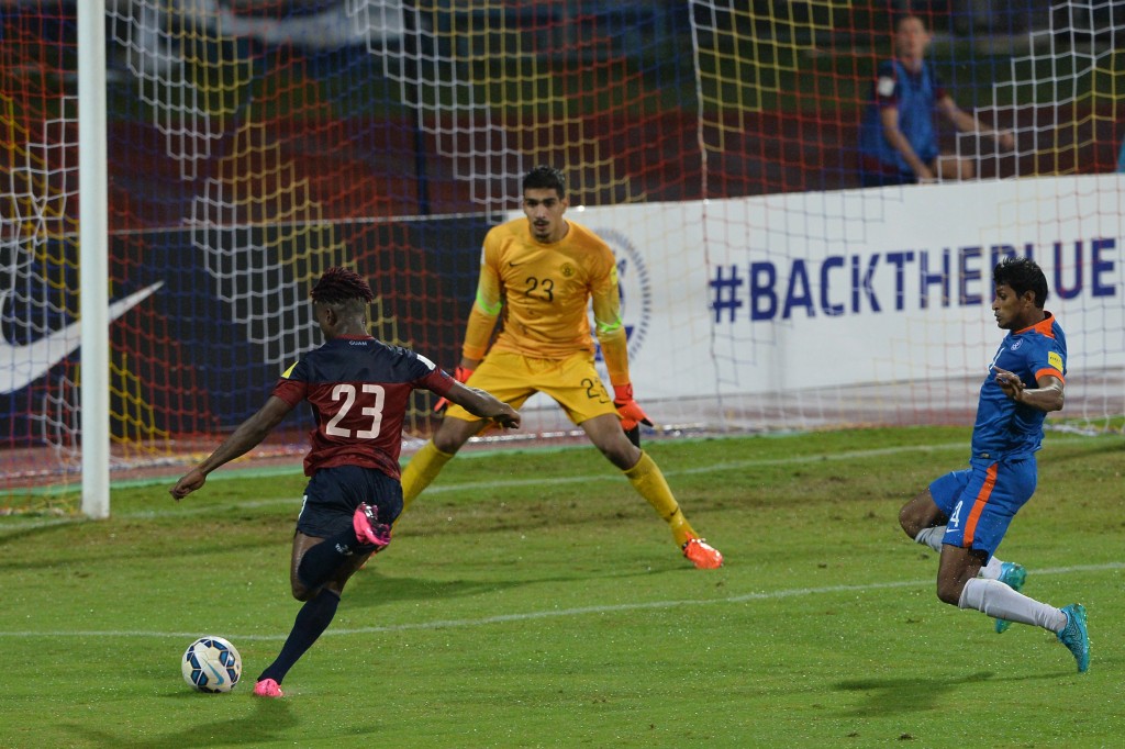 India's goalie Gurpreet Singh Sandhu (C) and player Arnad Kumar Mondal (R) look on as Guam's Shane Andre Malcom attempts a strike towards the goal during the the Asia Group D FIFA World Cup 2018 qualifying football match between India and Guam at The Sree KanteeraVa Stadium in Bangalore on November 12, 2015. AFP PHOTO/ Manjunath KIRAN (Photo credit should read Manjunath Kiran/AFP/Getty Images)