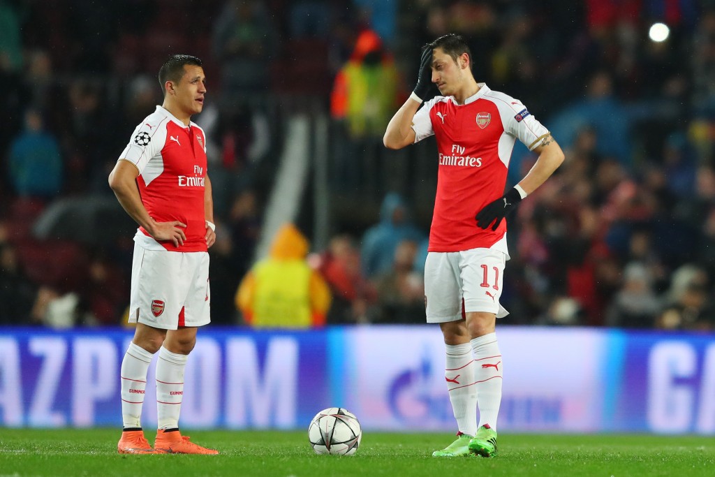 BARCELONA, SPAIN - MARCH 16: Alexis Sanchez (L) and Mesut Ozil (R) of Arsenal show their dejection after Barcelona's first goal during the UEFA Champions League round of 16, second Leg match between FC Barcelona and Arsenal FC at Camp Nou on March 16, 2016 in Barcelona, Spain. Time for a break. (Photo by Richard Heathcote/Getty Images)