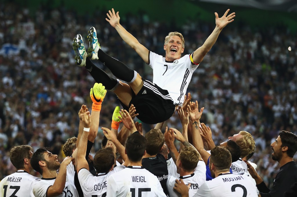 MOENCHENGLADBACH, GERMANY - AUGUST 31: Bastian Schweinsteiger of Germany is thrown in to the air by team mates after his last international match during the International Friendly match between Germany and Finland at Borussia-Park on August 31, 2016 in Moenchengladbach, Germany. (Photo by Lars Baron/Bongarts/Getty Images)
