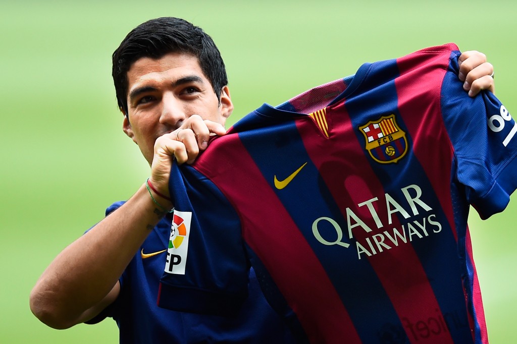 BARCELONA, SPAIN - AUGUST 19: Luis Suarez of FC Barcelona holds a FC Barcelona shirt during his presentation as new FC Barcelona player at Camp Nou on August 19, 2014 in Barcelona, Spain. (Photo by David Ramos/Getty Images)