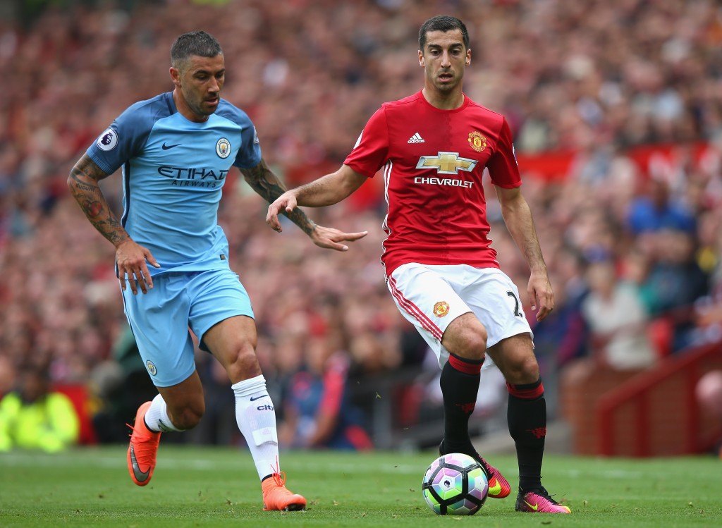 MANCHESTER, ENGLAND - SEPTEMBER 10: Henrikh Mkhitaryan of Manchester United (R) takes the ball past Aleksander Kolorov of Manchester City (L) during the Premier League match between Manchester United and Manchester City at Old Trafford on September 10, 2016 in Manchester, England. (Photo by Alex Livesey/Getty Images)