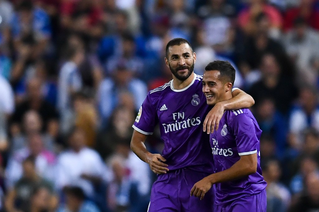 BARCELONA, SPAIN - SEPTEMBER 18: Karim Benzema (L) celebrates with his team mate Lucas Vazquez of Real Madrid CF after scoring his team's second goal during the La Liga match between RCD Espanyol and Real Madrid CF at the RCDE stadium on September 18, 2016 in Barcelona, Spain. (Photo by David Ramos/Getty Images)
