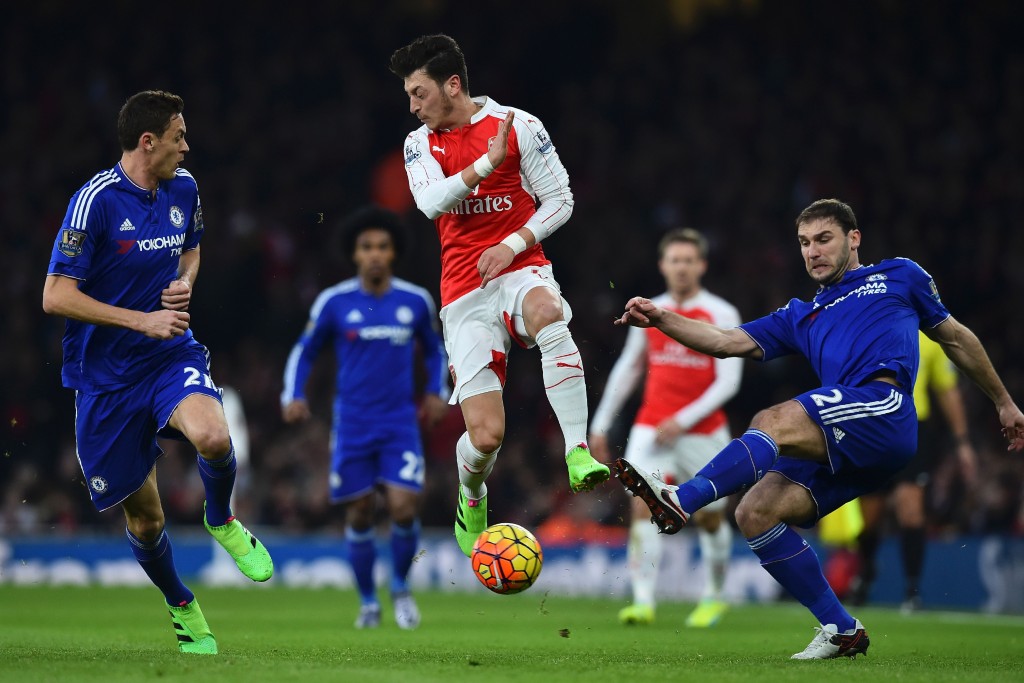 TOPSHOT - Arsenal's German midfielder Mesut Ozil (C) vies with Chelsea's Serbian midfielder Nemanja Matic (L) and Chelsea's Serbian defender Branislav Ivanovic (R) during the English Premier League football match between Arsenal and Chelsea at the Emirates Stadium in London on January 24, 2016. / AFP / BEN STANSALL (Photo credit should read BEN STANSALL/AFP/Getty Images)