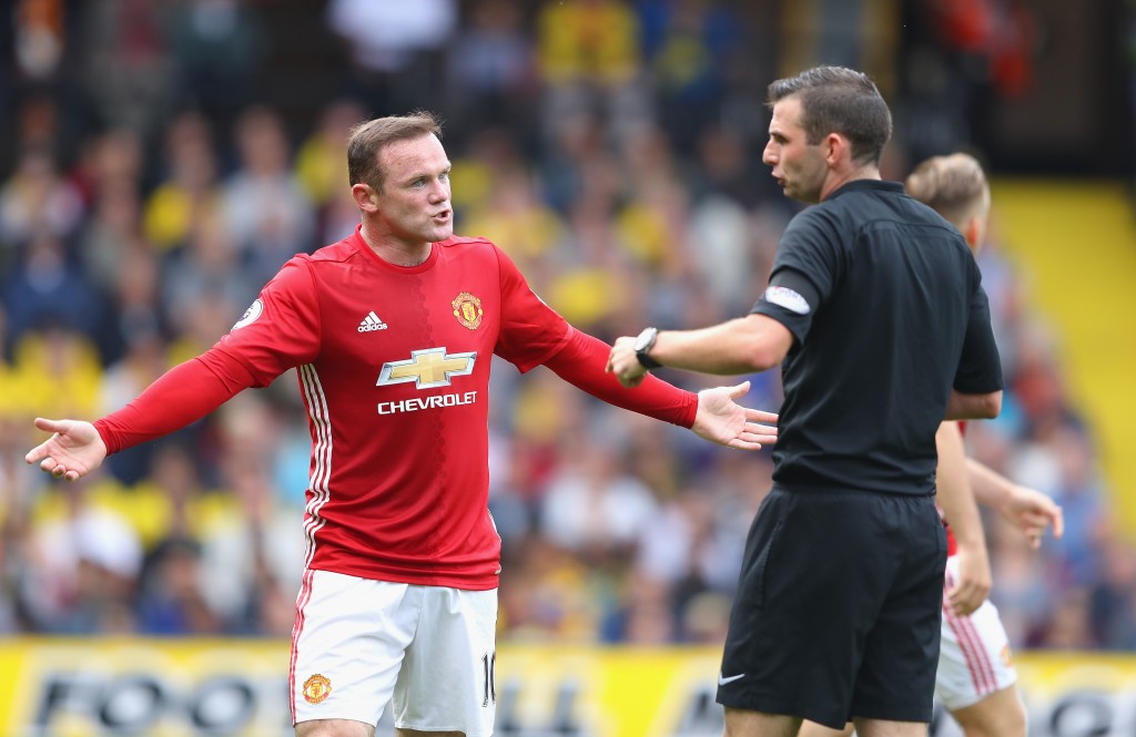 WATFORD, ENGLAND - SEPTEMBER 18: Wayne Rooney of Manchester United (L) argues with referee Michael Oliver during the Premier League match between Watford and Manchester United at Vicarage Road on September 18, 2016 in Watford, England. (Photo by Richard Heathcote/Getty Images)