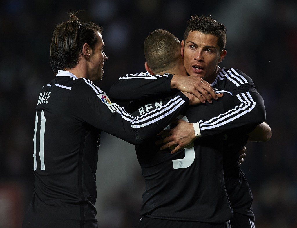 ELCHE, SPAIN - FEBRUARY 22: Karim Benzema of Real Madrid celebrates after scoring with his teammates Cristiano Ronaldo (R) and Gareth Bale during the La Liga match between Elche FC and Real Madrid at Estadio Manuel Martinez Valero on February 22, 2015 in Elche, Spain. (Photo by Manuel Queimadelos Alonso/Getty Images)