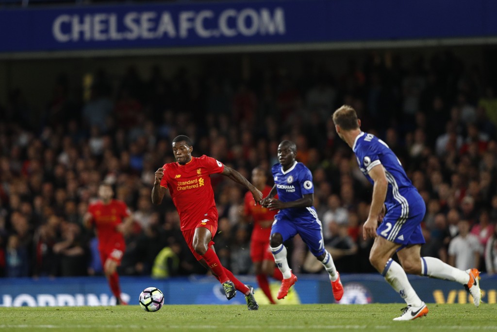 Liverpool's Dutch midfielder Georginio Wijnaldum (L) runs with the ball during the English Premier League football match between Chelsea and Liverpool at Stamford Bridge in London on September 16, 2016. / AFP / Adrian DENNIS / RESTRICTED TO EDITORIAL USE. No use with unauthorized audio, video, data, fixture lists, club/league logos or 'live' services. Online in-match use limited to 75 images, no video emulation. No use in betting, games or single club/league/player publications. / (Photo credit should read ADRIAN DENNIS/AFP/Getty Images)
