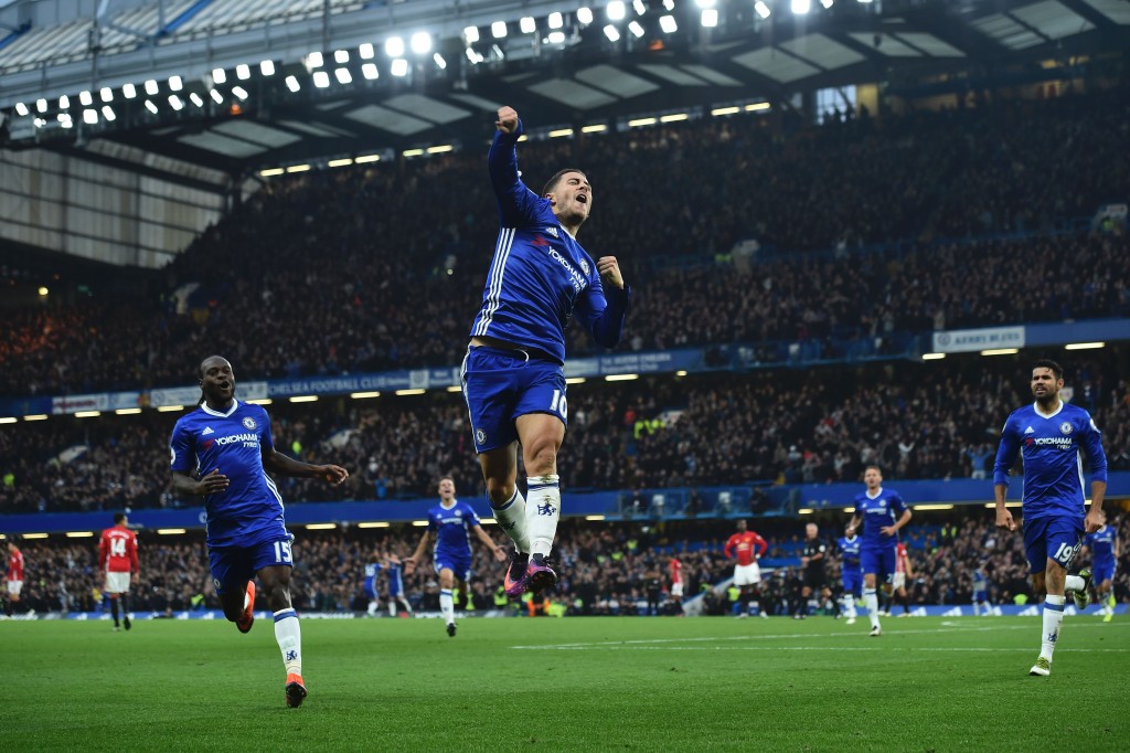 Chelsea's Belgian midfielder Eden Hazard (C) celebrates after scoring their third goal during the English Premier League football match between Chelsea and Manchester United at Stamford Bridge in London on October 23, 2016. / AFP / Glyn KIRK / RESTRICTED TO EDITORIAL USE. No use with unauthorized audio, video, data, fixture lists, club/league logos or 'live' services. Online in-match use limited to 75 images, no video emulation. No use in betting, games or single club/league/player publications. / (Photo credit should read GLYN KIRK/AFP/Getty Images)