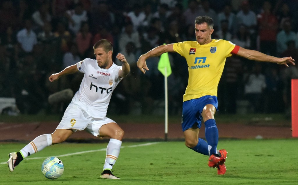 Northeast United FC's Emiliano Alfaro (L) is challenged for the ball by Kerala Blasters FC's defender Aaron Hughes during the Indian Super League (ISL) football match between Northeast United FC and Kerala Blasters FC at The Indira Gandhi Athletic Stadium in Guwahati on October 1, 2016. ----IMAGE RESTRICTED TO EDITORIAL USE - STRICTLY NO COMMERCIAL USE-- / AFP / Biju BORO (Photo credit should read BIJU BORO/AFP/Getty Images)
