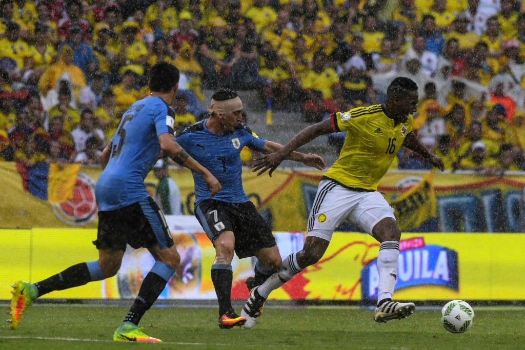 Uruguay's Cristian Rodriguez and Colombia's defender Yerry Mina (R) vie for the ball during their Russia 2018 FIFA World Cup qualifier football match in Barranquilla, Colombia, on October 11, 2016. (Photo by Luis Acosta/AFP/Getty Images)