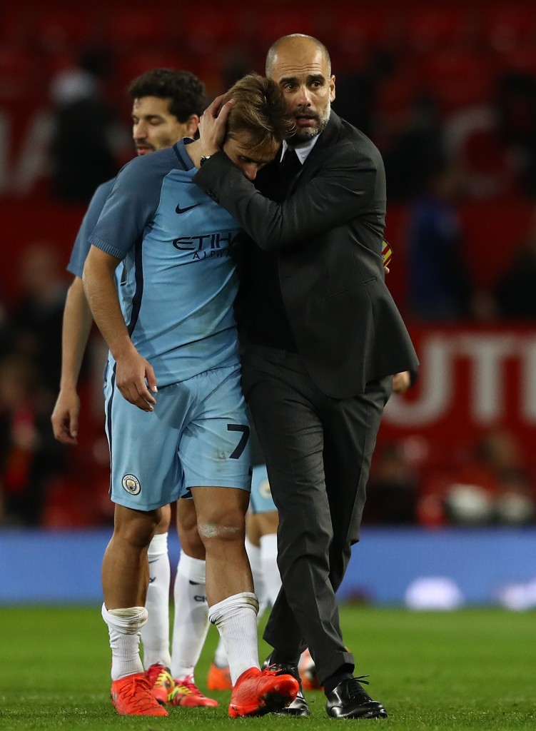 MANCHESTER, ENGLAND - OCTOBER 26: Josep Guardiola, Manager of Manchester City (R) embraces Aleix Garcia of Manchester City (L) after the final whistle during the EFL Cup fourth round match between Manchester United and Manchester City at Old Trafford on October 26, 2016 in Manchester, England. (Photo by David Rogers/Getty Images)