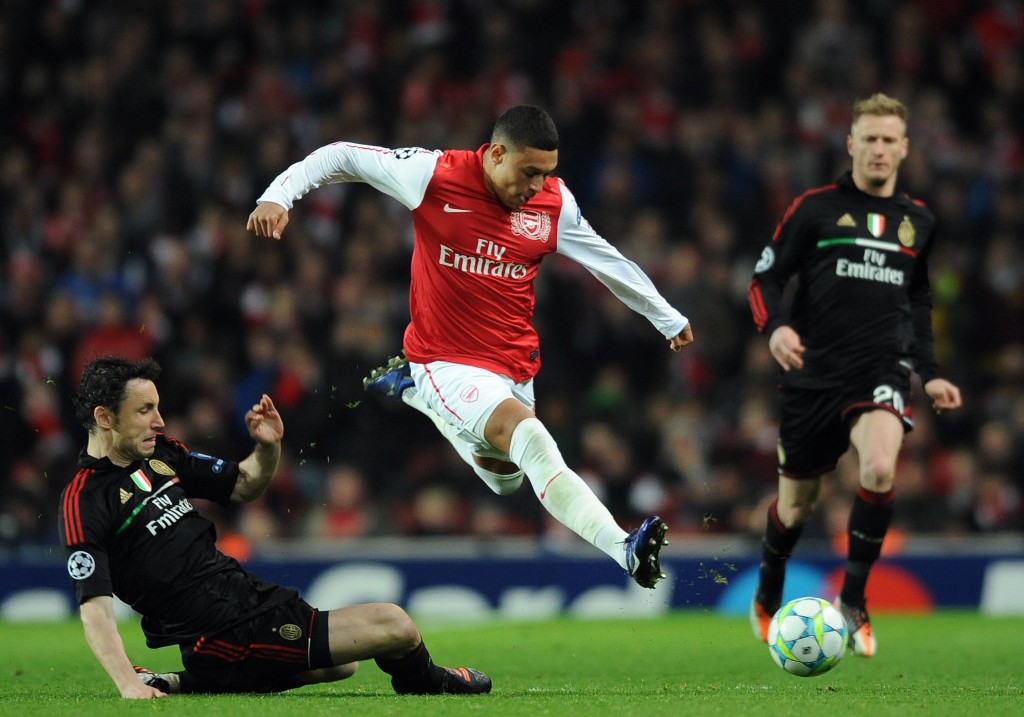 Arsenal's English striker Alex Oxlade-Chamberlain (R) vies with AC Milan's Dutch midfielder Mark Van Bommel (L) during an UEFA Champions League round of 16 second leg football match at the Emirates Stadium, North London, England on March 6, 2012. AFP PHOTO/ADRIAN DENNIS (Photo credit should read ADRIAN DENNIS/AFP/Getty Images)