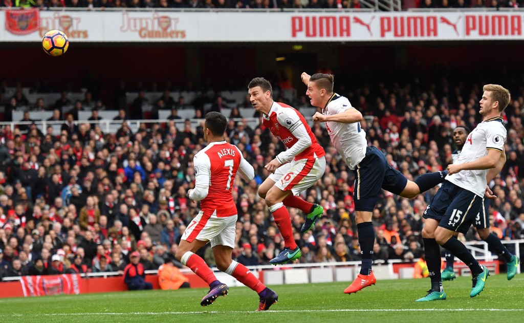 Tottenham Hotspur's Austrian defender Kevin Wimmer (2R) heads the ball past Arsenal's Chilean striker Alexis Sanchez (L) and Arsenal's French defender Laurent Koscielny (2L) to score an own goal during the English Premier League football match between Arsenal and Tottenham Hotspur at the Emirates Stadium in London on November 6, 2016. (Photo by Ben Stansall/AFP/Getty Images)