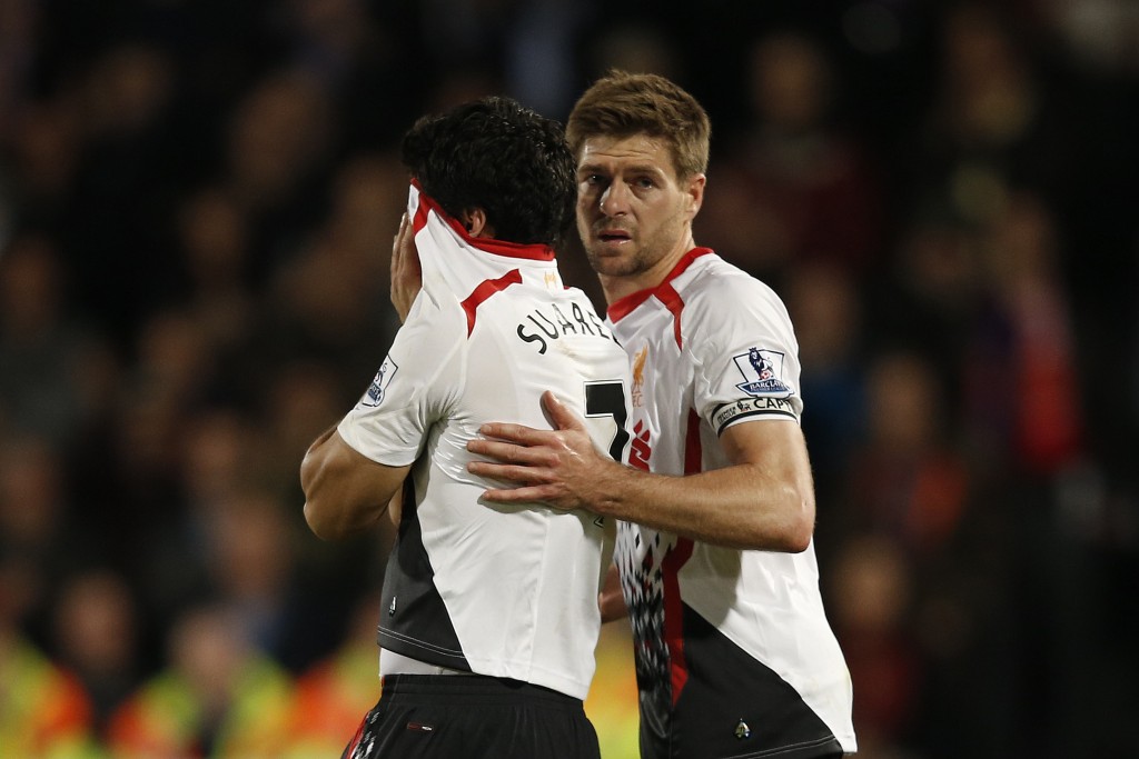 Liverpool's English midfielder Steven Gerrard (R) shepherds Liverpool's Uruguayan striker Luis Suarez (L) from the field as he reacts at the end of the English Premier League football match between Crystal Palace and Liverpool at Selhurst Park in south London on May 5, 2014. The match ended in a 3-3 draw. AFP PHOTO / ADRIAN DENNIS RESTRICTED TO EDITORIAL USE. No use with unauthorized audio, video, data, fixture lists, club/league logos or live services. Online in-match use limited to 45 images, no video emulation. No use in betting, games or single club/league/player publications. (Photo credit should read ADRIAN DENNIS/AFP/Getty Images)