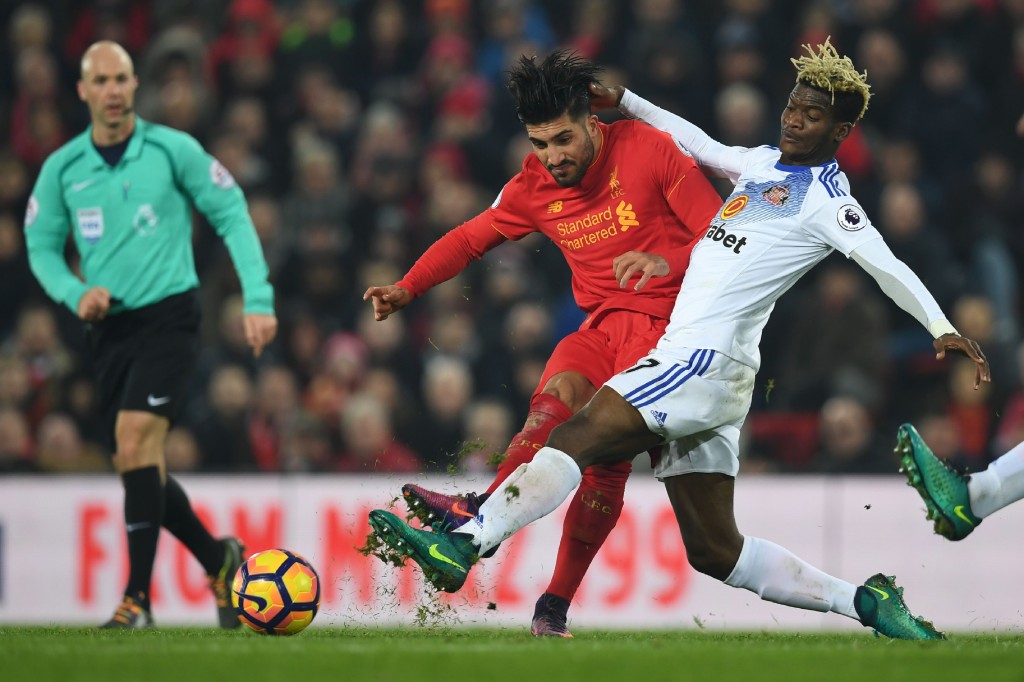 Liverpool's German midfielder Emre Can (L) plays the ball under pressure from Sunderland's Gabonese midfielder Didier N'Dong (R) during the English Premier League football match between Liverpool and Sunderland at Anfield in Liverpool, north west England on November 26, 2016. / AFP / Paul ELLIS / RESTRICTED TO EDITORIAL USE. No use with unauthorized audio, video, data, fixture lists, club/league logos or 'live' services. Online in-match use limited to 75 images, no video emulation. No use in betting, games or single club/league/player publications. / (Photo credit should read PAUL ELLIS/AFP/Getty Images)