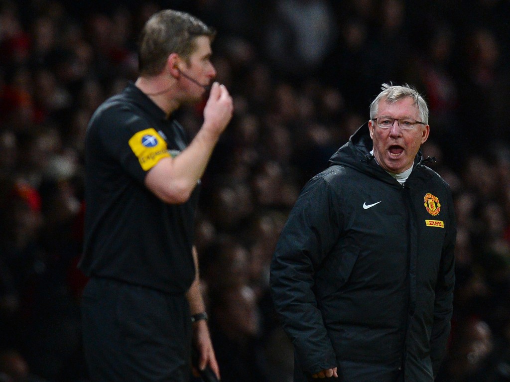 Manchester United's Scottish manager Alex Ferguson (R) shouts at assistant referee Jake Collin (L) during the English Premier League football match between Manchester United and Newcastle United at Old Trafford in Manchester, north-west England on December 26, 2012. AFP PHOTO/ANDREW YATES RESTRICTED TO EDITORIAL USE. No use with unauthorized audio, video, data, fixture lists, club/league logos or “live” services. Online in-match use limited to 45 images, no video emulation. No use in betting, games or single club/league/player publications (Photo credit should read ANDREW YATES/AFP/Getty Images)