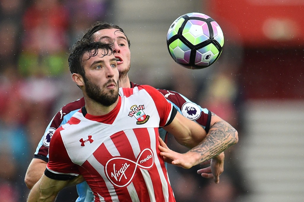 Southampton's English midfielder Sam McQueen (L) vies with Burnley's Australian midfielder Aiden O'Neill during the English Premier League football match between Southampton and Burnley at St Mary's Stadium in Southampton, southern England on October 16, 2016. / AFP / GLYN KIRK / RESTRICTED TO EDITORIAL USE. No use with unauthorized audio, video, data, fixture lists, club/league logos or 'live' services. Online in-match use limited to 75 images, no video emulation. No use in betting, games or single club/league/player publications. / (Photo credit should read GLYN KIRK/AFP/Getty Images)