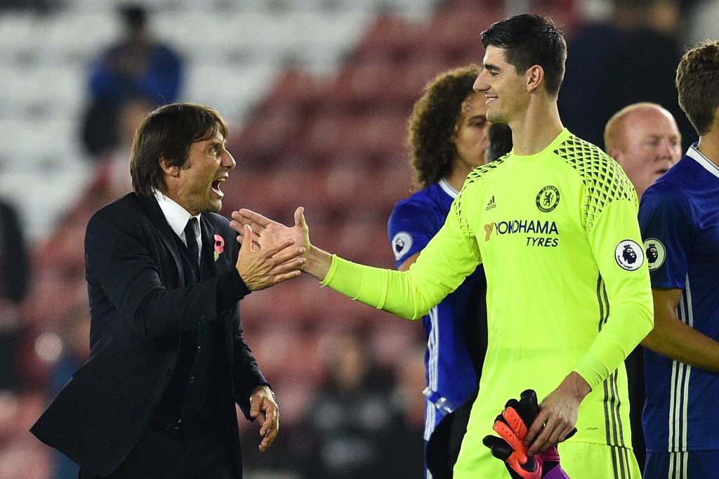 Chelsea's Italian head coach Antonio Conte (L) celebrates with Chelsea's Belgian goalkeeper Thibaut Courtois on the pitch after the English Premier League football match between Southampton and Chelsea at St Mary's Stadium in Southampton, southern England on October 30, 2016. Chelsea won the game 2-0. / AFP / GLYN KIRK / RESTRICTED TO EDITORIAL USE. No use with unauthorized audio, video, data, fixture lists, club/league logos or 'live' services. Online in-match use limited to 75 images, no video emulation. No use in betting, games or single club/league/player publications. / (Photo credit should read GLYN KIRK/AFP/Getty Images)