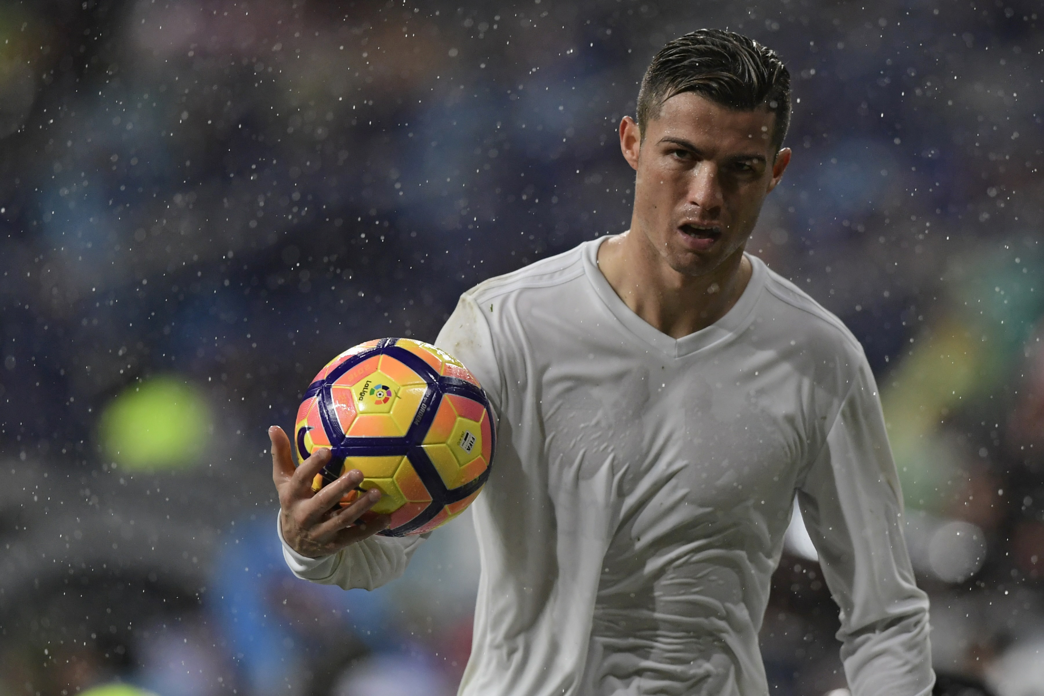 Real Madrid's Portuguese forward Cristiano Ronaldo holds a ball during the Spanish league football match Real Madrid CF vs Sporting de Gijon SAD at the Santiago Bernabeu stadium in Madrid on November 26, 2016. / AFP / JAVIER SORIANO (Photo credit should read JAVIER SORIANO/AFP/Getty Images)