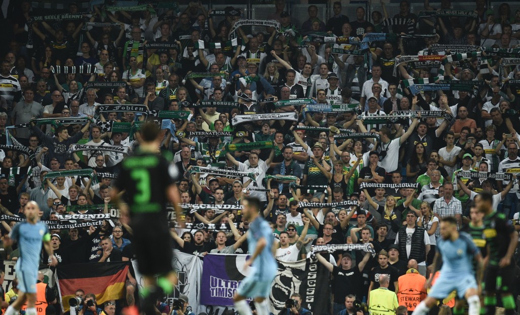 Monchengladbach fans hold up scarves during the UEFA Champions League group C football match between Manchester City and Borussia Monchengladbach at the Etihad stadium in Manchester, northwest England, on September 14, 2016. (Photo by Oli Scarff/AFP/Getty Images)