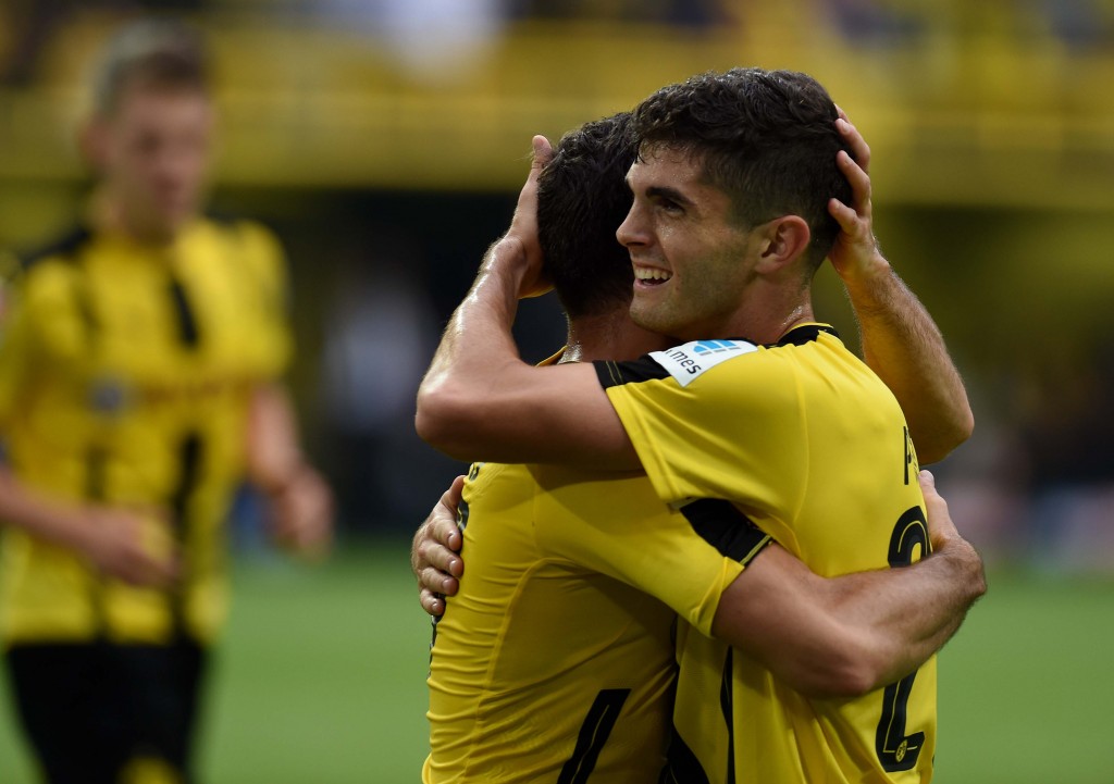 Dortmund's midfielder Gonzalo Castro and Dortmund's US midfielder Christian Pulisic celebrate during the German first division Bundesliga football match of Borussia Dortmund vs SV Darmstadt 98 in Dortmund, western Germany, on September 17, 2016. / AFP / PATRIK STOLLARZ / RESTRICTIONS: DURING MATCH TIME: DFL RULES TO LIMIT THE ONLINE USAGE TO 15 PICTURES PER MATCH AND FORBID IMAGE SEQUENCES TO SIMULATE VIDEO. == RESTRICTED TO EDITORIAL USE == FOR FURTHER QUERIES PLEASE CONTACT DFL DIRECTLY AT + 49 69 650050 (Photo credit should read PATRIK STOLLARZ/AFP/Getty Images)