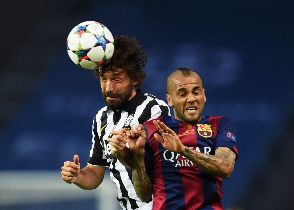BERLIN, GERMANY - JUNE 06: Andrea Pirlo of Juventus wins a header with Daniel Alves of Barcelona during the UEFA Champions League Final between Juventus and FC Barcelona at Olympiastadion on June 6, 2015 in Berlin, Germany. (Photo by Matthias Hangst/Getty Images)