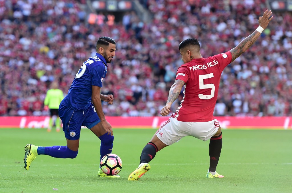 LONDON, ENGLAND - AUGUST 07: Riyad Mahrez of Leicester City takes the ball past Marcos Rojo of Manchester United during The FA Community Shield match between Leicester City and Manchester United at Wembley Stadium on August 7, 2016 in London, England. (Photo by Alex Broadway/Getty Images)