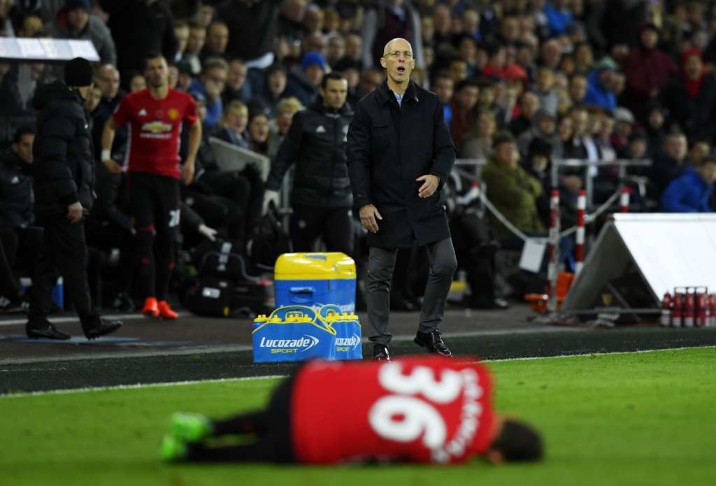 SWANSEA, WALES - NOVEMBER 06: Bob Bradley, Manager of Swansea City looks on as Matteo Darmian of Manchester United lies down injured during the Premier League match between Swansea City and Manchester United at Liberty Stadium on November 6, 2016 in Swansea, Wales. (Photo by Stu Forster/Getty Images)