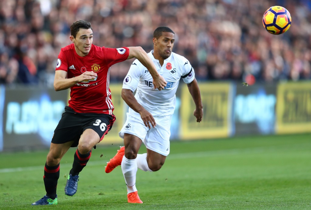 SWANSEA, WALES - NOVEMBER 06: Wayne Routledge of Swansea City and Matteo Darmian of Manchester United chase the ball during the Premier League match between Swansea City and Manchester United at Liberty Stadium on November 6, 2016 in Swansea, Wales. (Photo by Michael Steele/Getty Images)