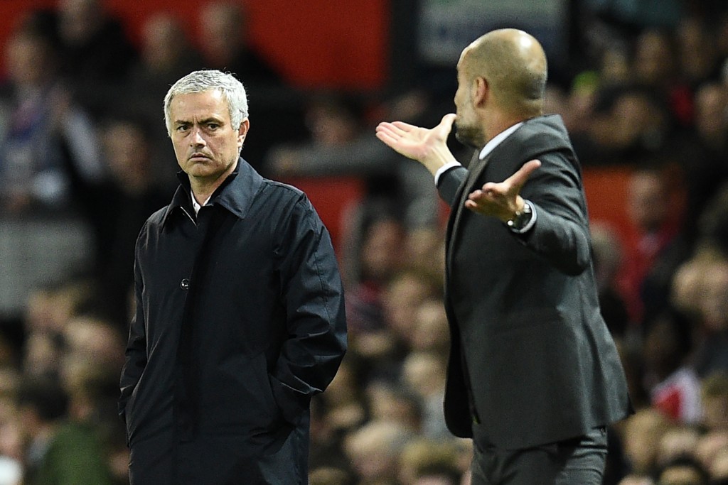 Manchester United's Portuguese manager Jose Mourinho (L) watches as Manchester City's Spanish manager Pep Guardiola gestures on the touchline during the EFL (English Football League) Cup fourth round match between Manchester United and Manchester City at Old Trafford in Manchester, north west England on October 26, 2016. (Photo by Oli Scarff/AFP/Getty Images)