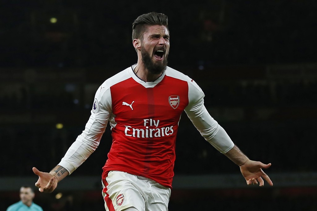 Arsenal's French striker Olivier Giroud celebrates after scoring the opening goal of the English Premier League football match between Arsenal and West Bromwich Albion at the Emirates Stadium in London on December 26, 2016. Arsenal won the game 1-0. / AFP / IAN KINGTON / RESTRICTED TO EDITORIAL USE. No use with unauthorized audio, video, data, fixture lists, club/league logos or 'live' services. Online in-match use limited to 75 images, no video emulation. No use in betting, games or single club/league/player publications. / (Photo credit should read IAN KINGTON/AFP/Getty Images)