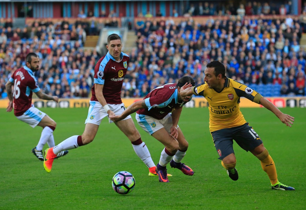 Arsenal's Spanish midfielder Santi Cazorla (R) vies with Burnley's Scottish midfielder George Boyd (2nd R), Burnley's Irish defender Stephen Ward (2nd L) and Burnley's Belgian midfielder Steven Defour (L) during the English Premier League football match between Burnley and Arsenal at Turf Moor in Burnley, north west England on October 2, 2016. / AFP / Lindsey PARNABY / RESTRICTED TO EDITORIAL USE. No use with unauthorized audio, video, data, fixture lists, club/league logos or 'live' services. Online in-match use limited to 75 images, no video emulation. No use in betting, games or single club/league/player publications. / (Photo credit should read LINDSEY PARNABY/AFP/Getty Images)