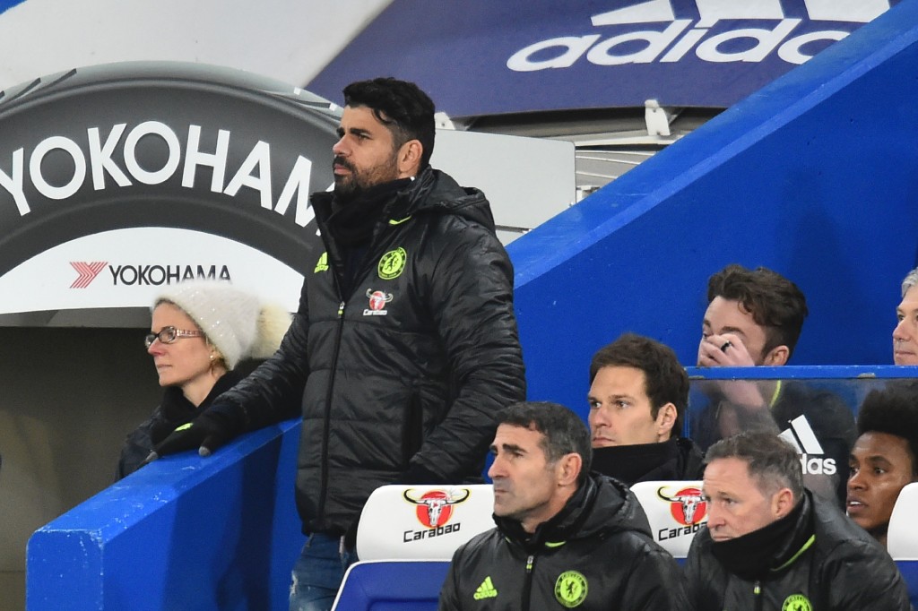 Chelsea's Brazilian-born Spanish striker Diego Costa stands by the dug out having been suspended for the English Premier League football match between Chelsea and Bournemouth at Stamford Bridge in London on December 26, 2016. (Photo by Glyn Kirk/AFP/Getty Images)