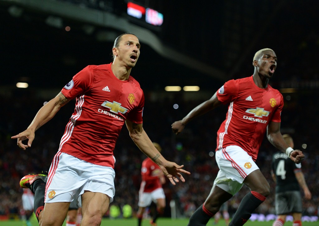 Manchester United's Swedish striker Zlatan Ibrahimovic (L) celebrates with Manchester United's French midfielder Paul Pogba after scoring their second goal from the penalty spot during the English Premier League football match between Manchester United and Southampton at Old Trafford in Manchester, north west England, on August 19, 2016. / AFP / Oli SCARFF / RESTRICTED TO EDITORIAL USE. No use with unauthorized audio, video, data, fixture lists, club/league logos or 'live' services. Online in-match use limited to 75 images, no video emulation. No use in betting, games or single club/league/player publications. / (Photo credit should read OLI SCARFF/AFP/Getty Images)