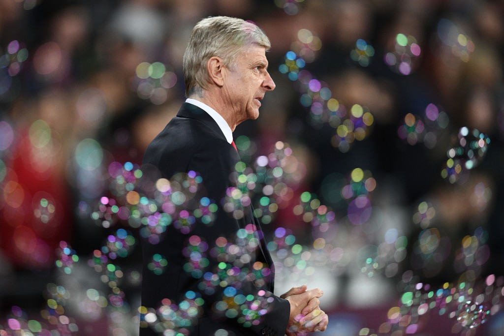 Arsenal's French manager Arsene Wenger walks in the bubbles before the English Premier League football match between West Ham United and Arsenal at The London Stadium, in east London on December 3, 2016. / AFP / Justin TALLIS / RESTRICTED TO EDITORIAL USE. No use with unauthorized audio, video, data, fixture lists, club/league logos or 'live' services. Online in-match use limited to 75 images, no video emulation. No use in betting, games or single club/league/player publications. / (Photo credit should read JUSTIN TALLIS/AFP/Getty Images)