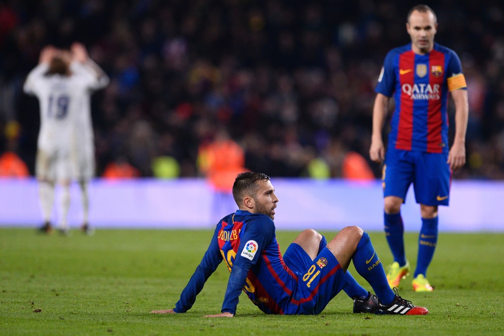 Barcelona's defender Jordi Alba sits on the pitch as he reacts following their 1-1 draw at the end of the Spanish league football match FC Barcelona vs Real Madrid CF at the Camp Nou stadium in Barcelona on December 3, 2016. / AFP / JOSEP LAGO (Photo credit should read JOSEP LAGO/AFP/Getty Images)