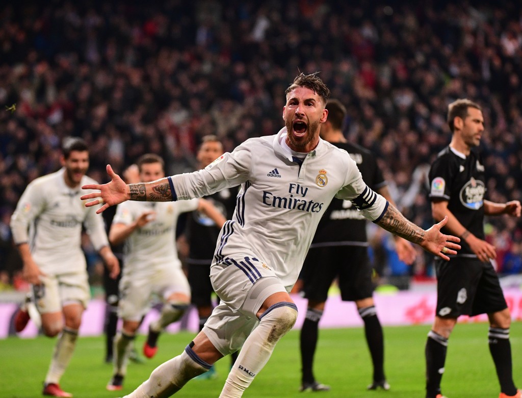 Real Madrid's defender Sergio Ramos celebrates after scoring during the Spanish league football match Real Madrid CF vs RC Deportivo at the Santiago Bernabeu stadium in Madrid on December 10, 2016. / AFP / PIERRE-PHILIPPE MARCOU (Photo credit should read PIERRE-PHILIPPE MARCOU/AFP/Getty Images)