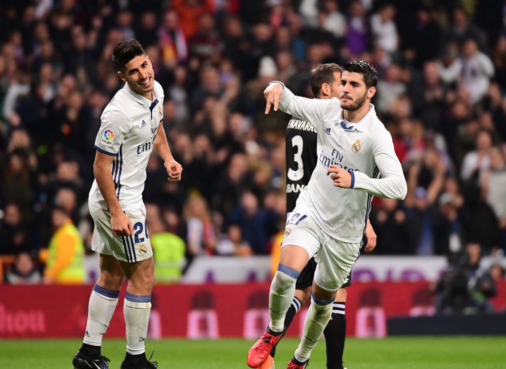 Real Madrid's forward Alvaro Morata (R) celebrates after scoring during the Spanish league football match Real Madrid CF vs RC Deportivo at the Santiago Bernabeu stadium in Madrid on December 10, 2016. / AFP / PIERRE-PHILIPPE MARCOU (Photo credit should read PIERRE-PHILIPPE MARCOU/AFP/Getty Images)