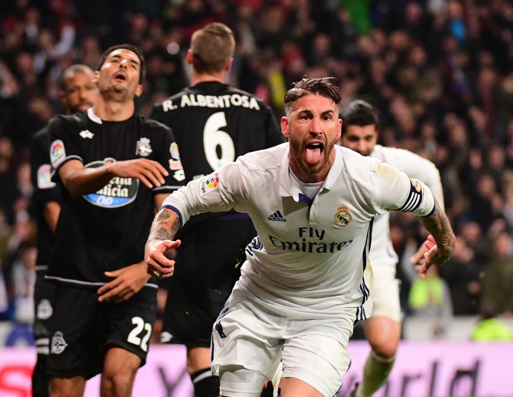 Real Madrid's defender Sergio Ramos celebrates after scoring during the Spanish league football match Real Madrid CF vs RC Deportivo at the Santiago Bernabeu stadium in Madrid on December 10, 2016. / AFP / PIERRE-PHILIPPE MARCOU (Photo credit should read PIERRE-PHILIPPE MARCOU/AFP/Getty Images)