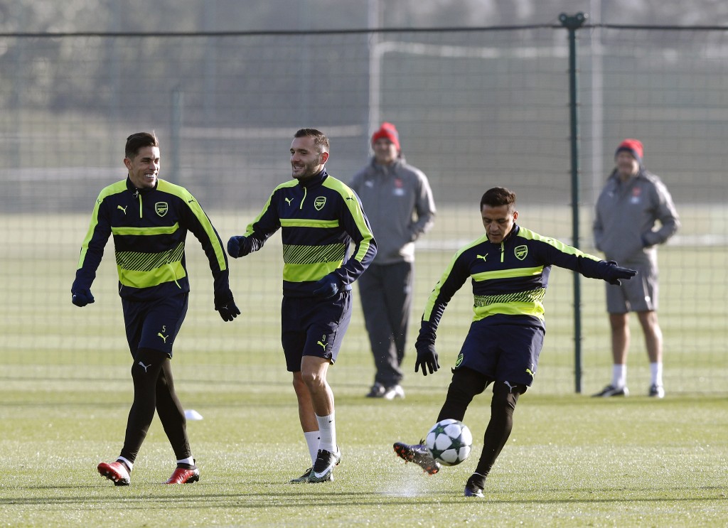 Arsenal's Chilean striker Alexis Sanchez (R) kicks the ball alongside Gabriel (L) and Lucas Perez during a training session at the club's complex in London Colney on December 5, 2016. Arsenal play FC Basel in a UEFA Champions League Group A match tomorrow. / AFP / ADRIAN DENNIS (Photo credit should read ADRIAN DENNIS/AFP/Getty Images)
