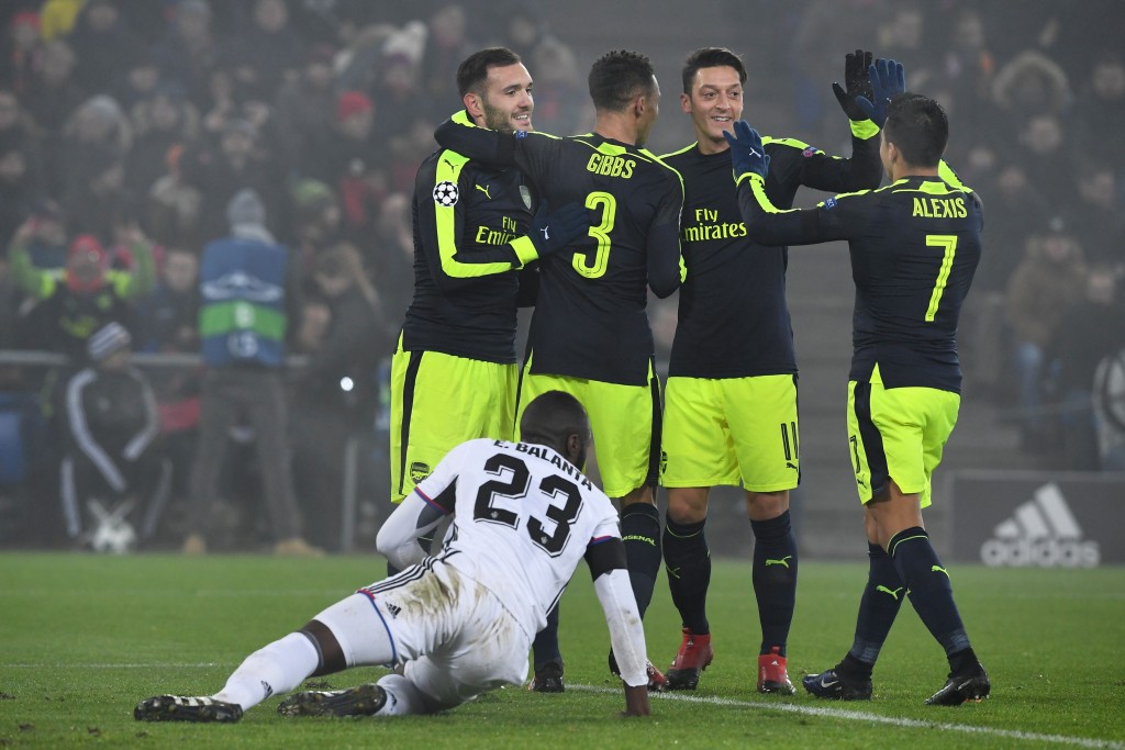 (From L- top) Arsenal's Spanish forward Lucas Perez celebrates after scoring a goal with his teammates Arsenal's English defender Kieran Gibbs, Arsenal's German midfielder Mesut Ozil and Arsenal's Chilean forward Alexis Sanchez, next to Basel's Colombian defender Eder Balanta during the UEFA Champions league Group A football match between FC Basel 1893 and Arsenal FC on December 6, 2016 at the St Jakob Park stadium in Basel. / AFP / Patrick HERTZOG (Photo credit should read PATRICK HERTZOG/AFP/Getty Images)