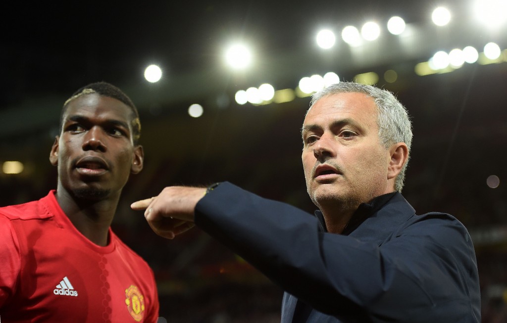Manchester United's Portuguese manager Jose Mourinho (R) gestures to Manchester United's French midfielder Paul Pogba as he arrives on the pitch ahead of the UEFA Europa League group A football match between Manchester United and Zorya Luhansk at Old Trafford stadium in Manchester, north-west England, on September 29, 2016. / AFP / PAUL ELLIS (Photo credit should read PAUL ELLIS/AFP/Getty Images)