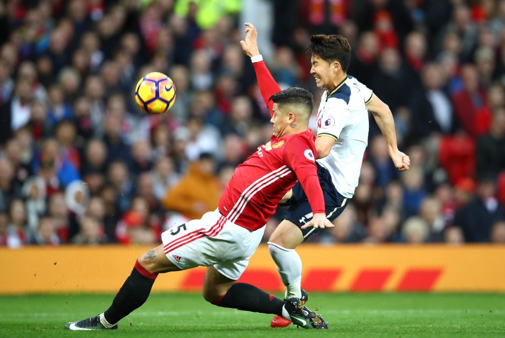 MANCHESTER, ENGLAND - DECEMBER 11: Heung-Min Son of Tottenham Hotspur and Marcos Rojo of Manchester United compete for the ball during the Premier League match between Manchester United and Tottenham Hotspur at Old Trafford on December 11, 2016 in Manchester, England. (Photo by Clive Brunskill/Getty Images)