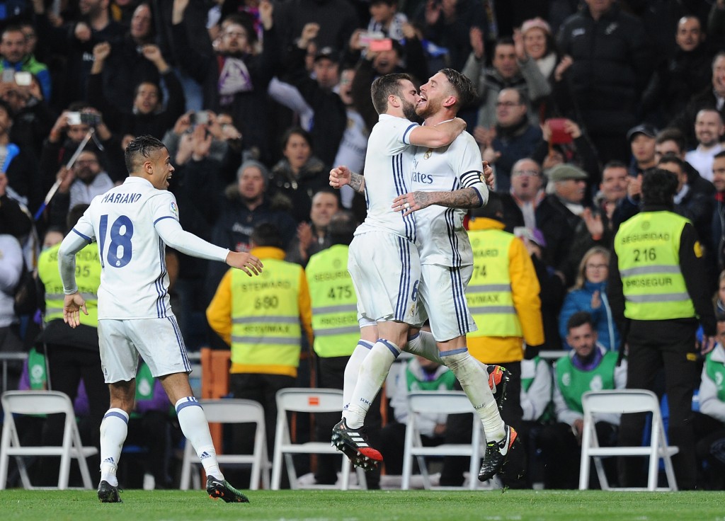 MADRID, SPAIN - DECEMBER 10: Sergio Ramos of Real Madrid celebrates with Nacho after scoring their 3rd goal during the La Liga match between Real Madrid CF and RC Deportivo La Coruna at Estadio Santiago Bernabeu on December 10, 2016 in Madrid, Spain. (Photo by Denis Doyle/Getty Images)